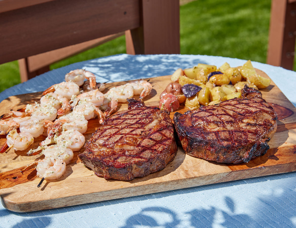 Royal Ranch Ribeye and Grilled Prawns with Garlic Herb Butter